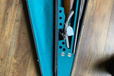 Vintage shotgun in violin case