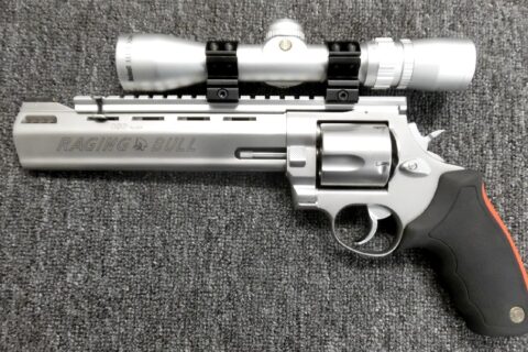 Preowned, Excellent Condition, Taurus Raging Bull Large-Frame Revolver, .480 Ruger, 8.4″ VR Barrel, 5 Rounds, SA/DA, Rubber Grips, Bushnell 3200 2-6×32 Scope, Includes Shoulder Holster, Soft Case, 50+ Rounds Hornady 325gr XTP Ammo: Only $997!